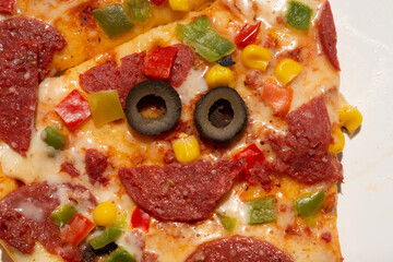 pizza in the shape of a smiley face with pizza and salami