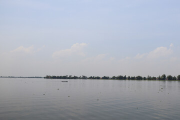 Naklejka premium Small fishing boat and island in lake