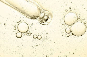 The texture of a cosmetic serum with a pipette closeup. Macrophotography