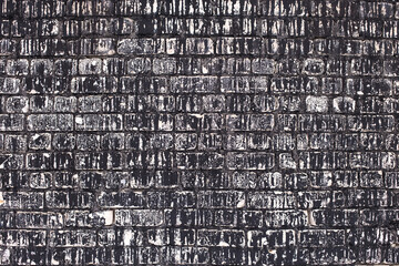 Old brick black color wall background. Dark stone texture