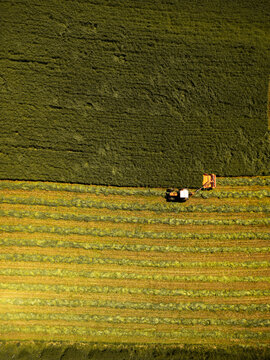 Agricultural field witn tractor aerial drone view in springtime