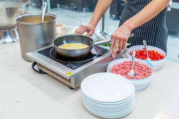 Chef preparing omelets at a live cooking station