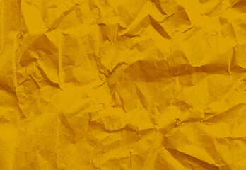 close up texture of yellow crumpled or torn old craft paper use as background with blank space for...