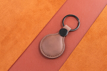 brown leather round Keychain on leather background