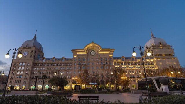 City Square Winter Park Fuzuli Park old building with clock, Baku, Azerbaijan hyperlapse timelapse day to night transformation sunset 4K