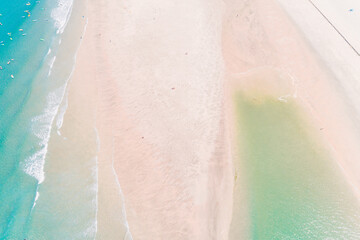 people on the shore of a beach enjoying the summer, aerial top view with a drone.