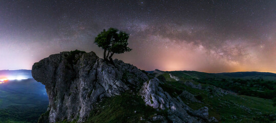 panoramic view of the Milky Way the Portupekoleze arch in the Urbasa Natural Park, Navarra with a...