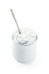 Granular cottage cheese with cream in a glass jar isolated on white