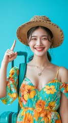 A woman wearing a floral dress and a straw hat is smiling and pointing to her luggage. She is excited about her upcoming trip