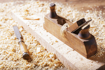 old tools: wooden planer and chisel in a carpentry workshop