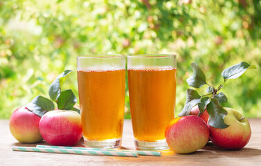 Glasses of apple juice and fresh fruits