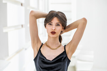 Portrait of a young girl in a long black evening dress