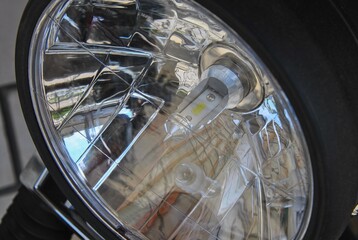 motorcycle headlight with modern led light bulb close-up. concept of safe road traffic.