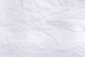 Flat lay of blank blue lined paper with textured, wrinkled backdrop.