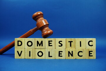 Domestic Violence alphabet letters with wooden blocks alphabet letters and Gavel on blue background