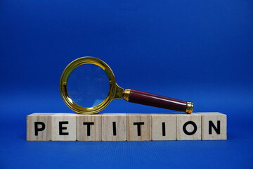 Petition alphabet letters with wooden blocks alphabet letters and Magnifying glass on blue background