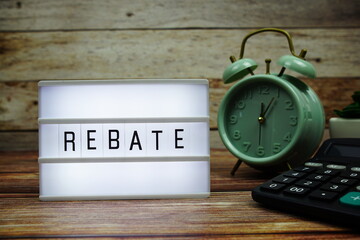 REBATE letterboard text on LED Lightbox on wooden background, business and promotion concept background