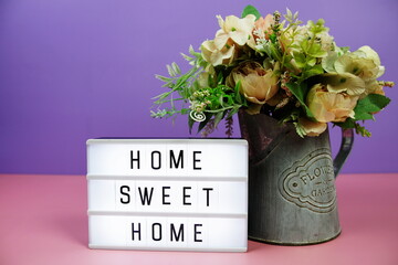 Home Sweet Home letterboard text on LED Lightbox on pink and purple background