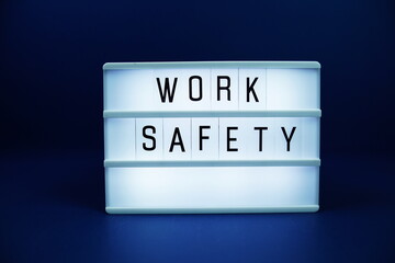 Work Safety letterboard text on LED Lightbox on blue background