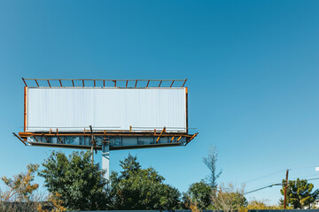 High-quality mockup location featuring an empty billboard and clear blue sky.