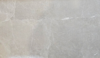 A light gray marble surface with intricate natural patterns and veins