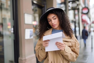 portrait of a young woman getting the mail