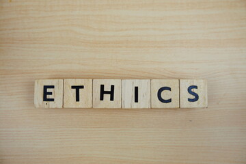 ETHICS alphabet letters top view on wooden background