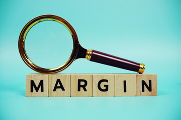 Margin with wooden blocks alphabet letters and Magnifying glass on blue background