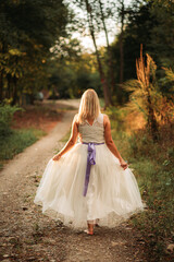 Beautiful blonde lady woman in white dress outdoors