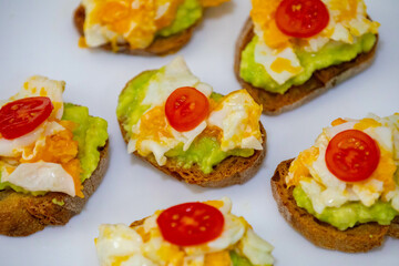Healthy breakfast, toast with avocado, eggs and tomatoes