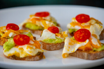 Healthy breakfast, toast with avocado, eggs and tomatoes