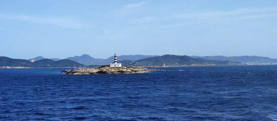 Obraz premium mediterranean lighthouse in a island between ibiza and formentera