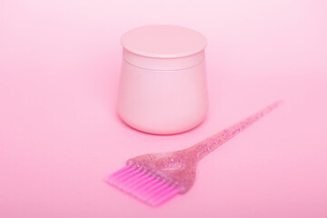 Pink jar for hair shampoo and brush
