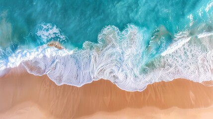 Beautiful aerial perspective of ocean waves lapping against a sandy beach, capturing the essence of summer vacation settings