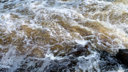 Aerial view of the waves and rapids of the wild river. abstract nature background. surface of water...