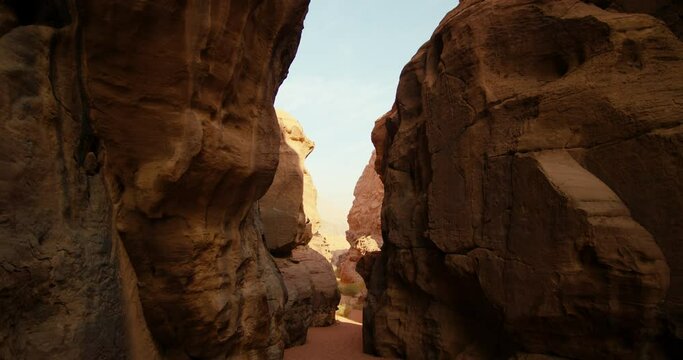 Scenic Sandstone Mountain Canyon in Wadi Rum Desert in Jordan, Middle East. Unearthly Gorge as famous landmark tourist attraction - Valley of Light, Sand and Moon. 4K gimbal zoom in shot at daytime