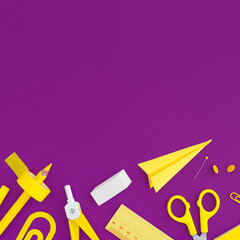 School supplies on purple background. Top view. Back to school. Flat lay.