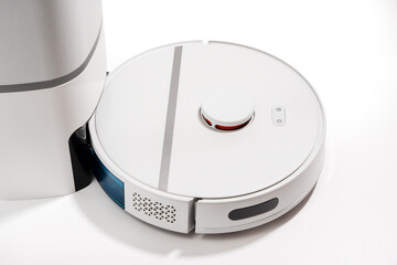A white robot vacuum cleaner with a blue compartment on the bottom.