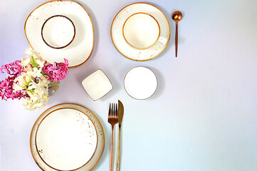 Elegant festive table setting. Cutlery with flowers on a plate on a marble background., menu layout...