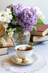 Cup of tea, bouquet of lilacs, spring still life.