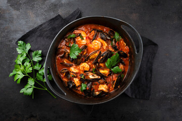 Traditional Creole cajun court bouillon with mussels and prawn gumbo chowder stew as top view in a pot