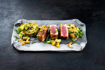 Traditional Japanese gourmet tuna fish steak tataki with tropical fruit tartar and cashew nuts...