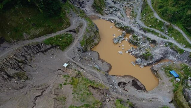 4k aerial footage of the area at the foot of Mount Merapi which consists of ravines that become lava flows, dense forests and hills that formed naturally when the mountain erupted some time ago