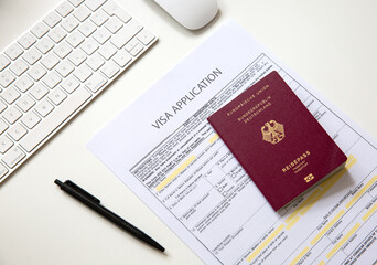 Top view of a visa application document with a German passport