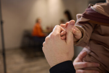 A close up of a persons thumb touching a baby tiny finger