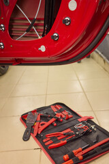 Closeup of red car door with perforated holes in automotive exterior