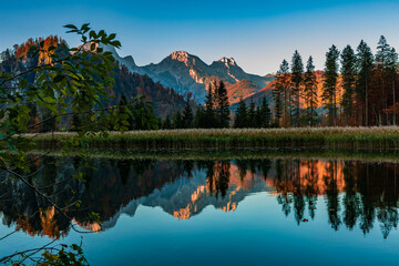 Sunrise at Almsee, Upper Austria with Autumn Colors and Mountain Reflections