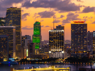 Obraz premium Buildings of Downtown Miami on an orange sunset sky