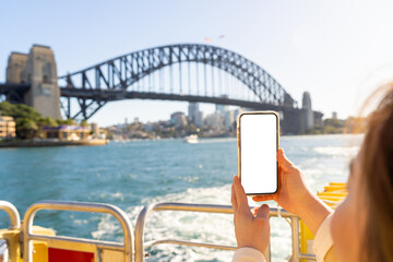 Asian woman working mobile phone or online booking hotel during travel on ferry boat crossing Sydney harbour, Australia. Attractive girl enjoy outdoor lifestyle travel in the city on holiday vacation.