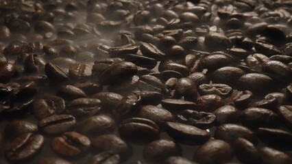 Close up of fresh brown coffee bean with roasted smoke from pile of coffee beans. Macrography of...